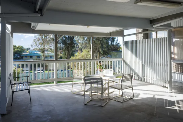 a view of a chairs and table in the patio