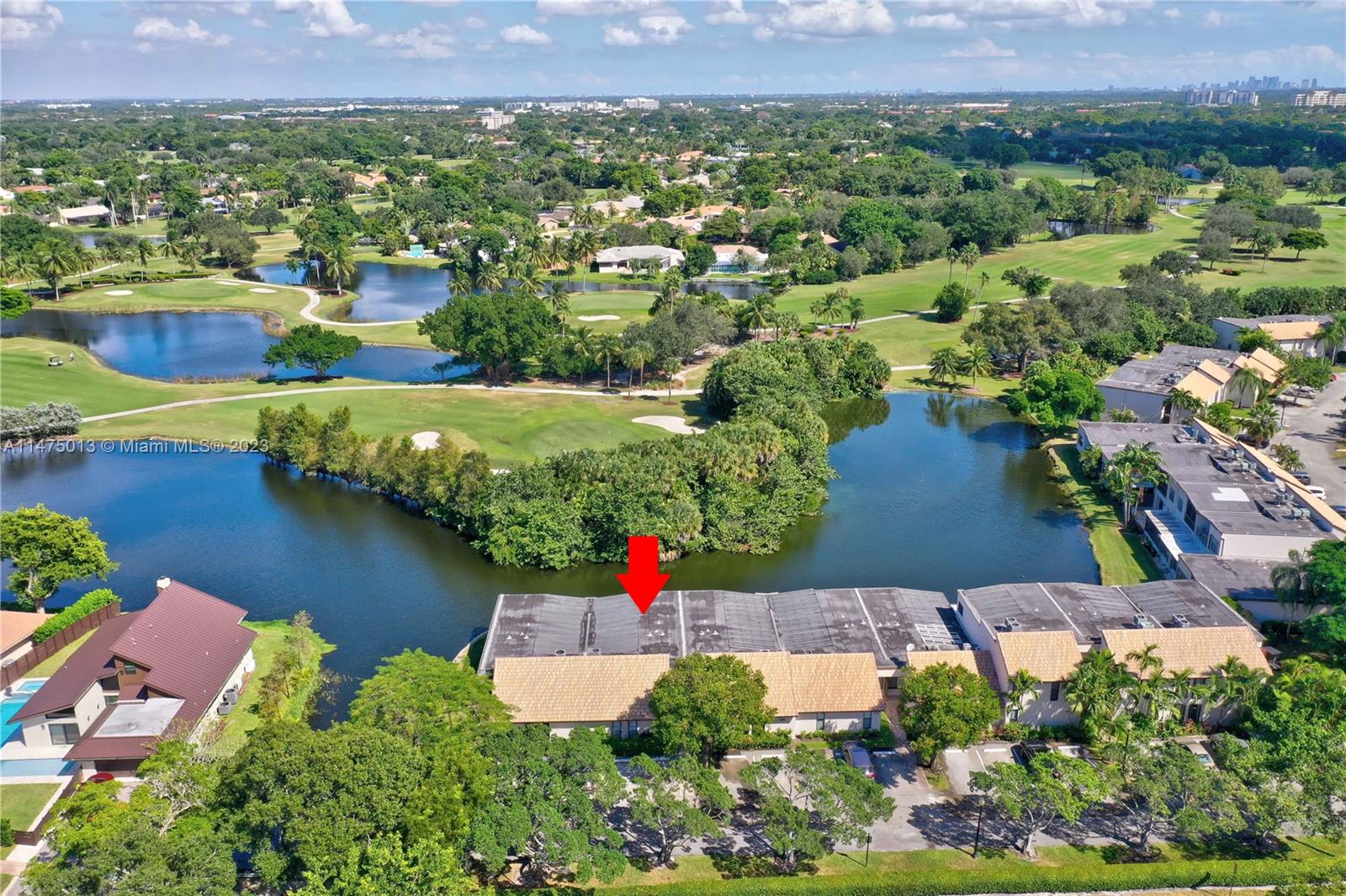 an aerial view of residential houses with outdoor space and lake view