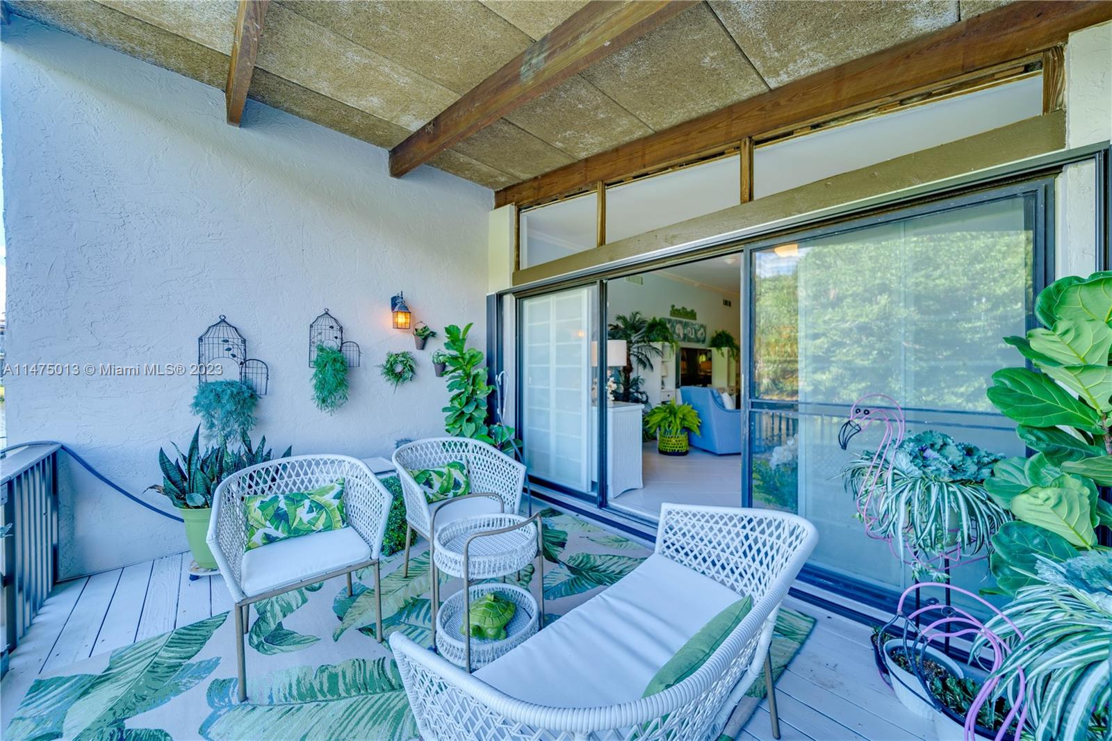 950 Mockingbird Lane, Unit 609A Plantation, FL 33324 - Photo 13 of 64 a living room with furniture and flowers