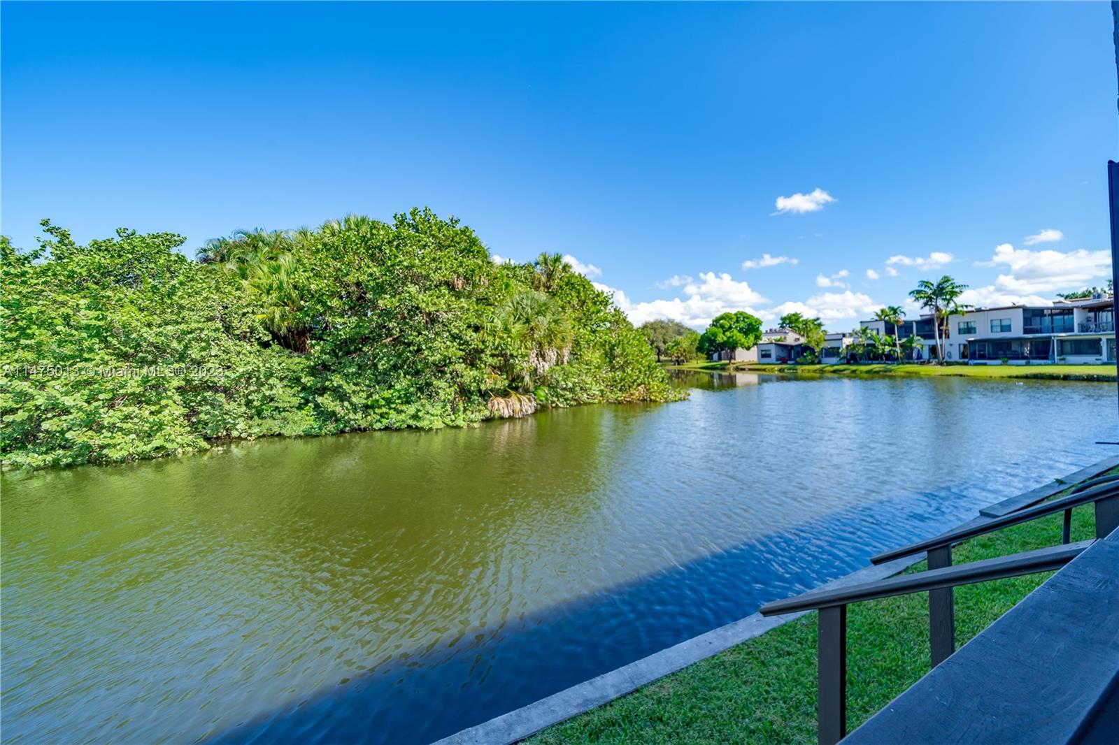 950 Mockingbird Lane, Unit 609A Plantation, FL 33324 - Photo 15 of 64 a view of a lake with a house in the background