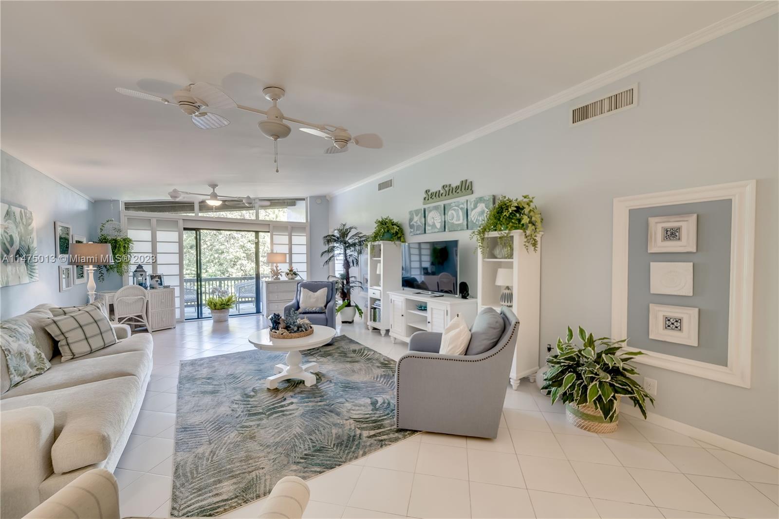 950 Mockingbird Lane, Unit 609A Plantation, FL 33324 - Photo 30 of 64 a living room with furniture potted plant and a large window