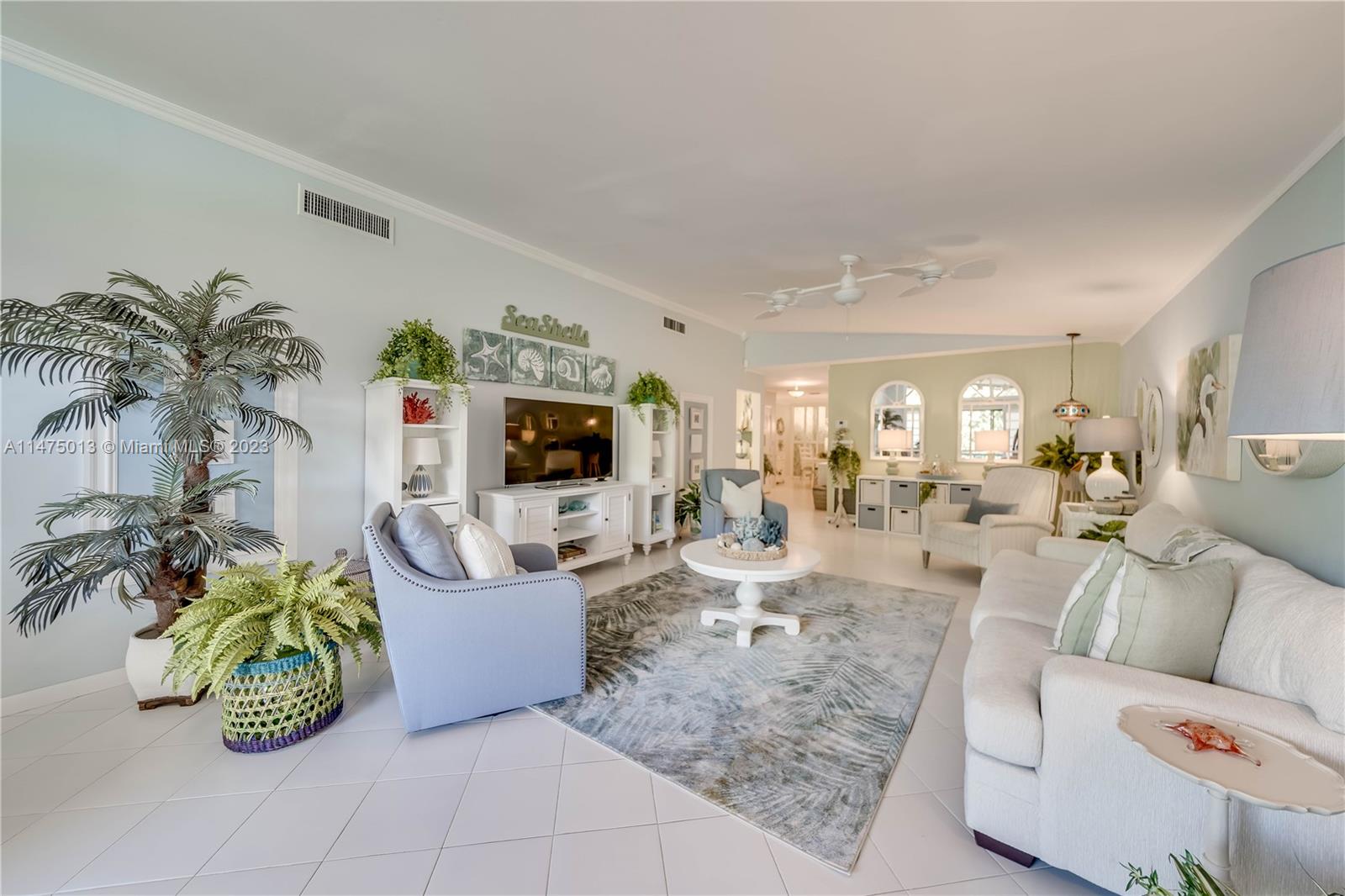 950 Mockingbird Lane, Unit 609A Plantation, FL 33324 - Photo 31 of 64 a living room with furniture and a flat screen tv