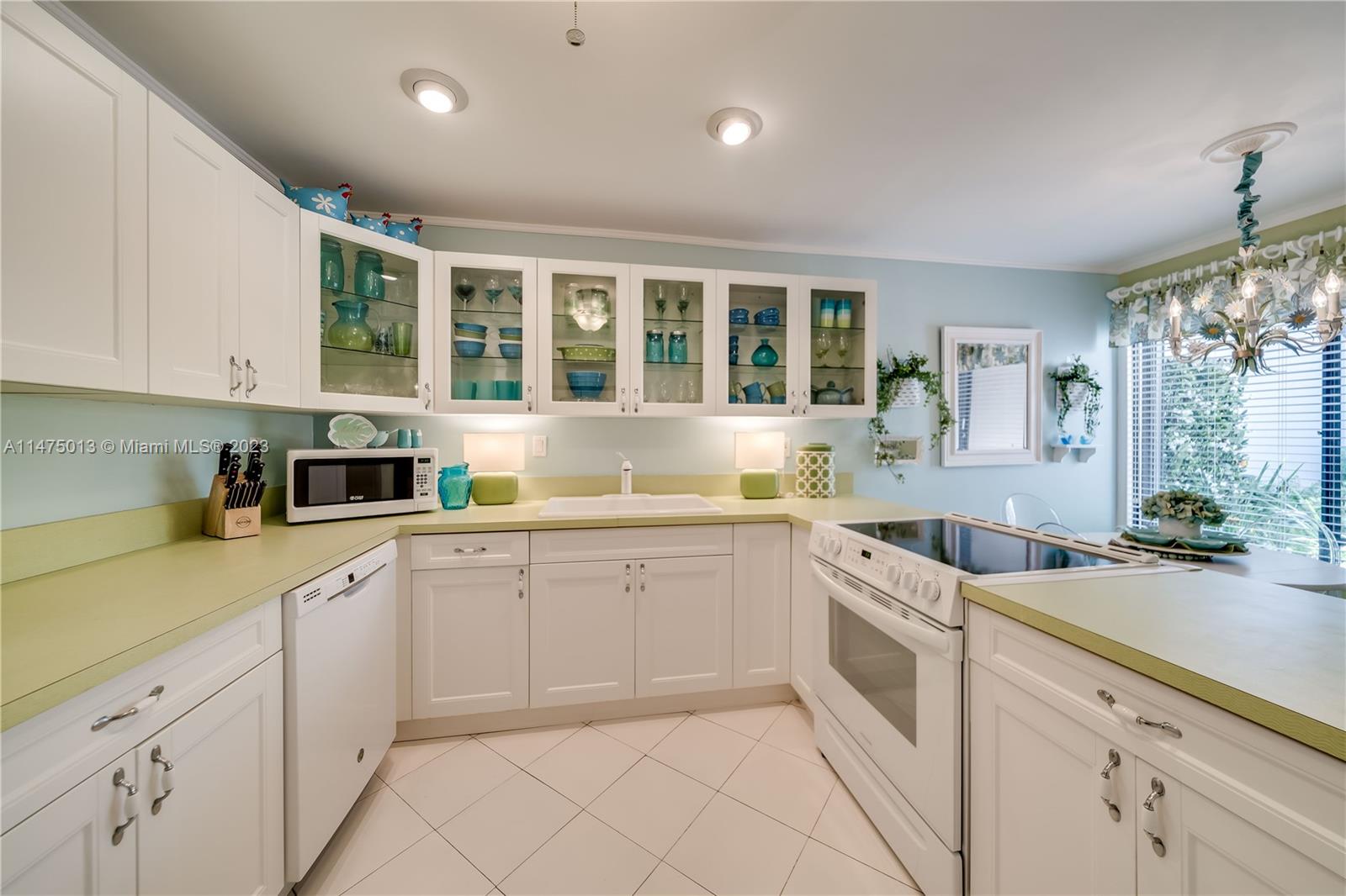 950 Mockingbird Lane, Unit 609A Plantation, FL 33324 - Photo 39 of 64 a kitchen with white cabinets and sink