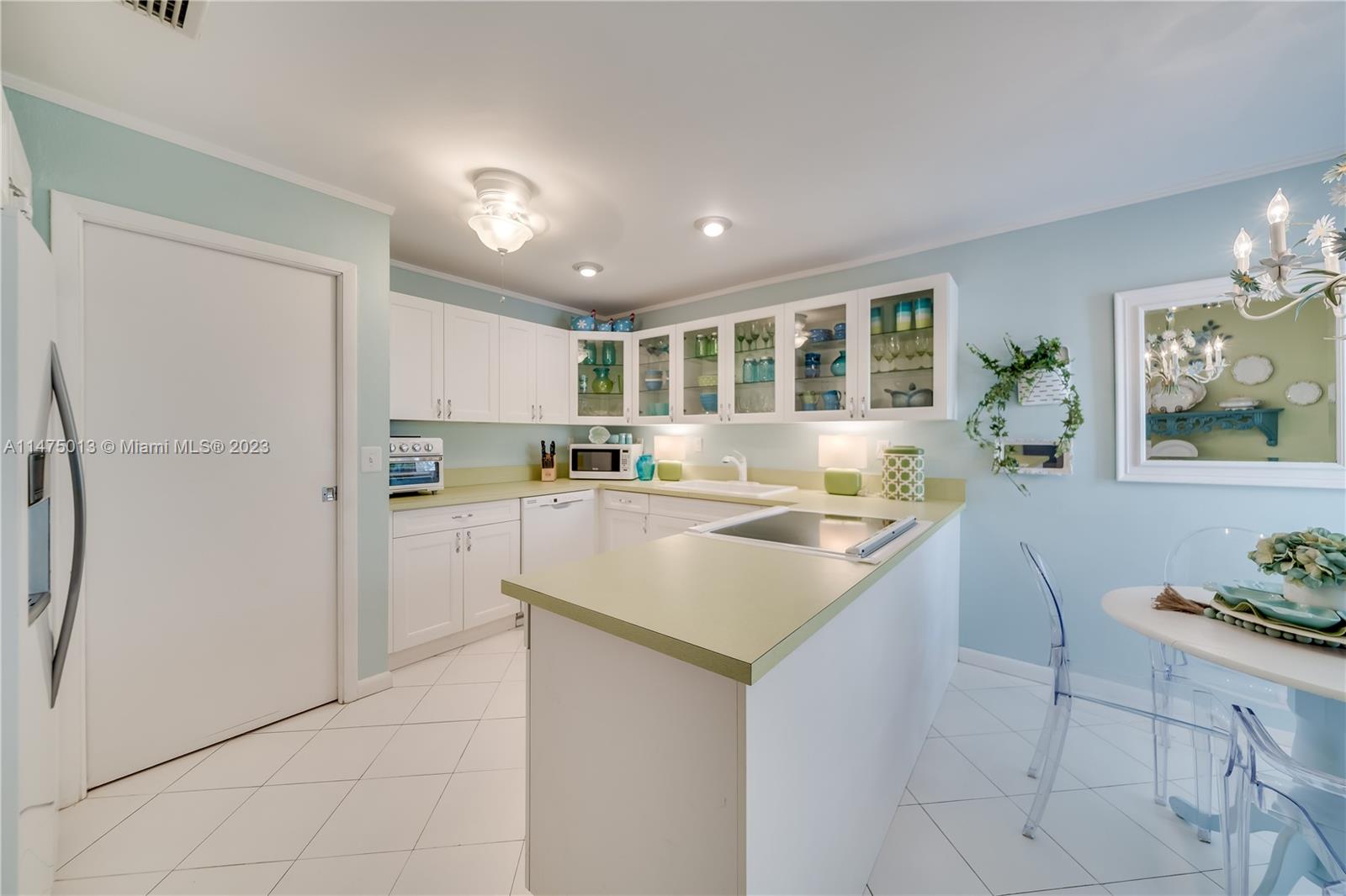 950 Mockingbird Lane, Unit 609A Plantation, FL 33324 - Photo 42 of 64 a kitchen with refrigerator and cabinets