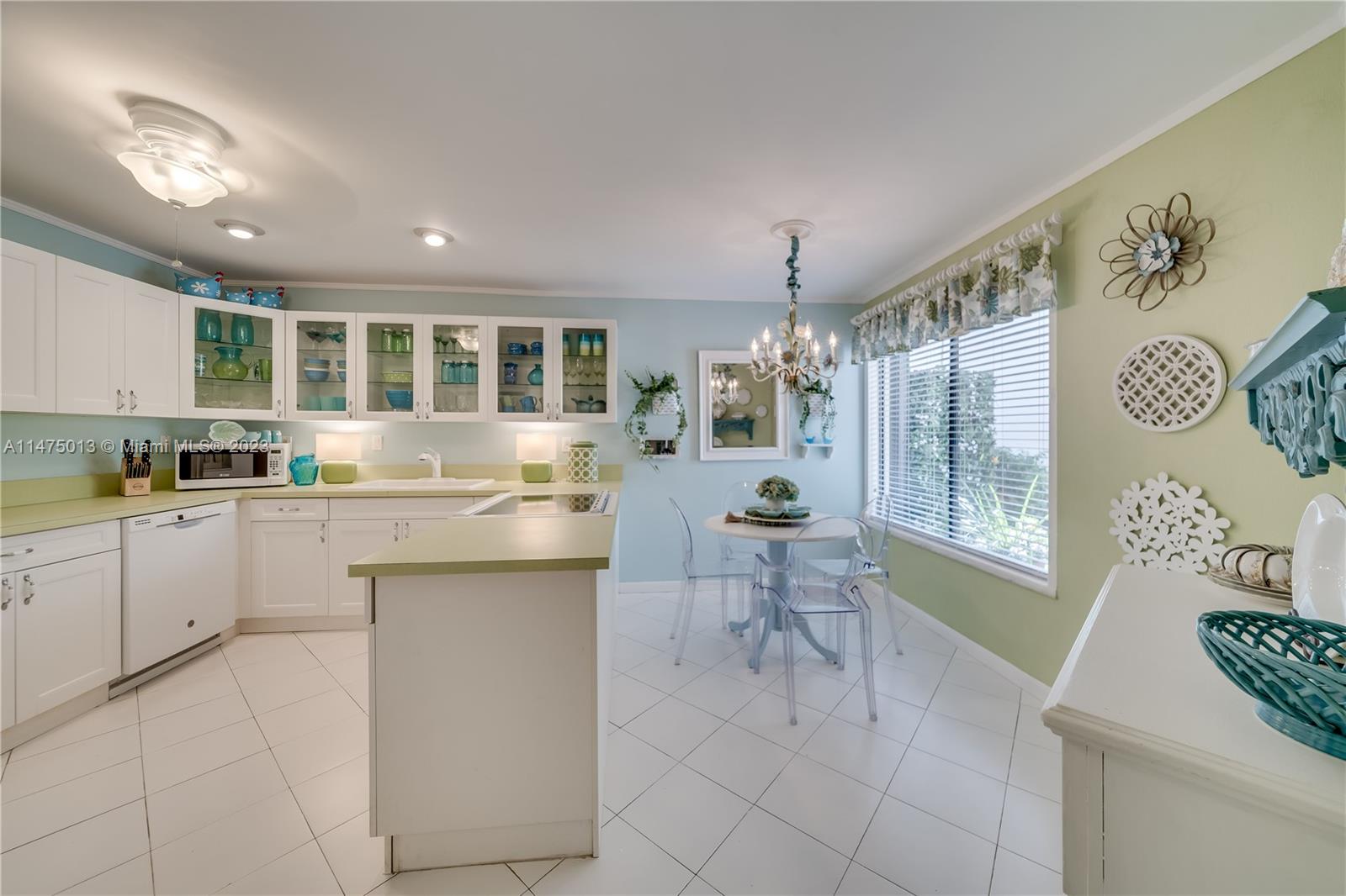 950 Mockingbird Lane, Unit 609A Plantation, FL 33324 - Photo 45 of 64 a kitchen with cabinets and chairs