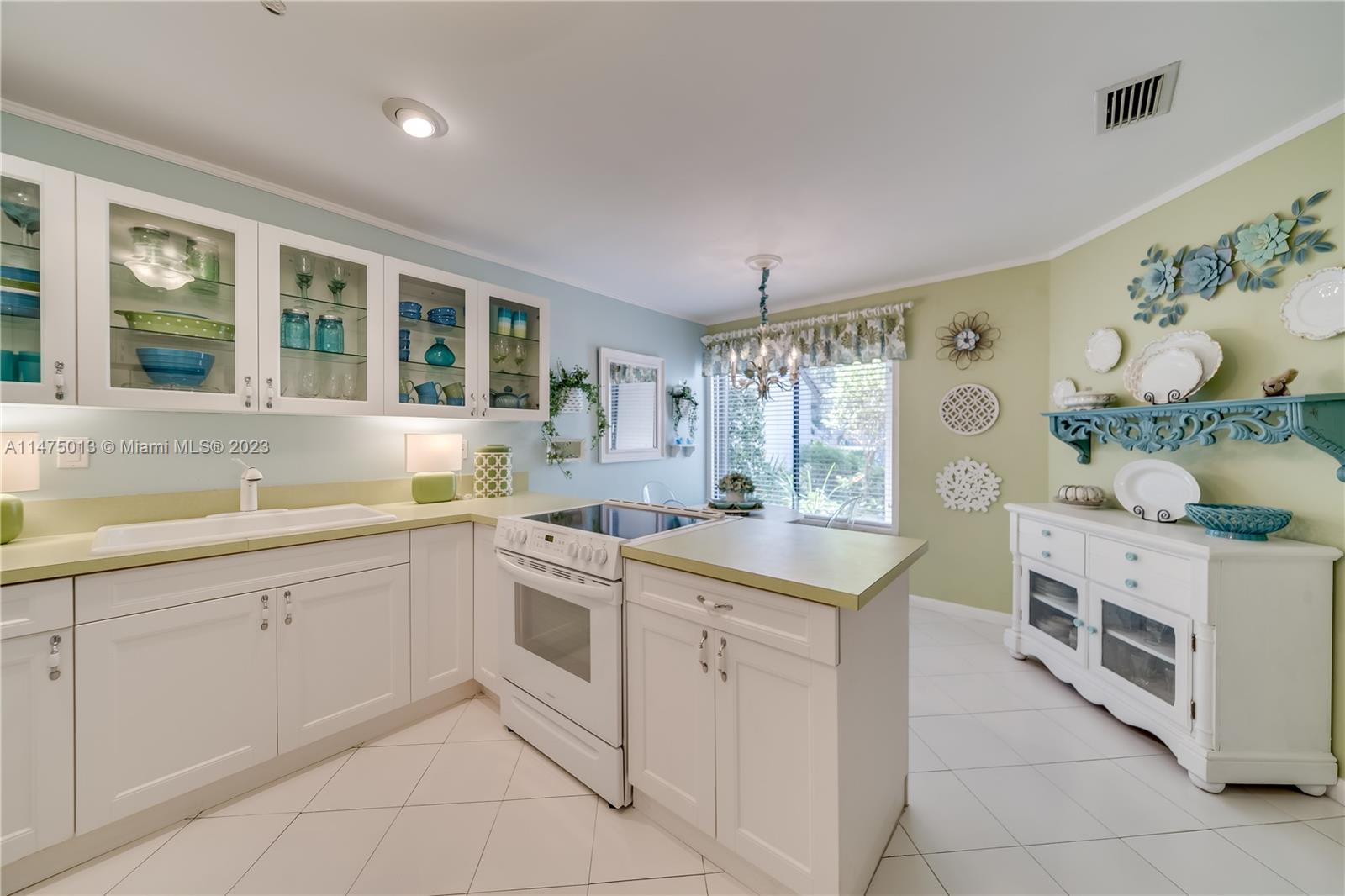 950 Mockingbird Lane, Unit 609A Plantation, FL 33324 - Photo 5 of 64 a kitchen with cabinets and window