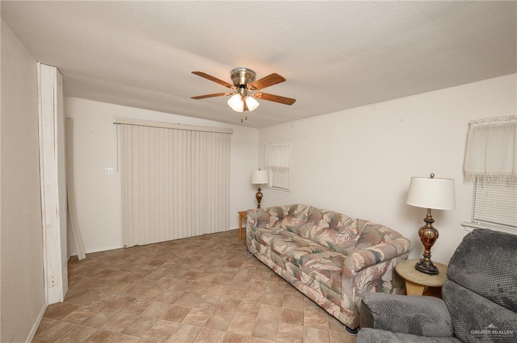 215 South Valley View Road, Unit 227 Donna, TX 78537 - Photo 14 of 18 a bedroom with a bed and a chandelier