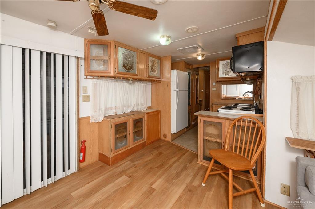 215 South Valley View Road, Unit 227 Donna, TX 78537 - Photo 5 of 18 a view of a kitchen with furniture and wooden floor