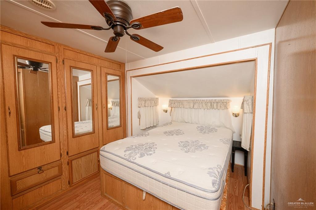 215 South Valley View Road, Unit 227 Donna, TX 78537 - Photo 9 of 18 a room with a bed and a ceiling fan