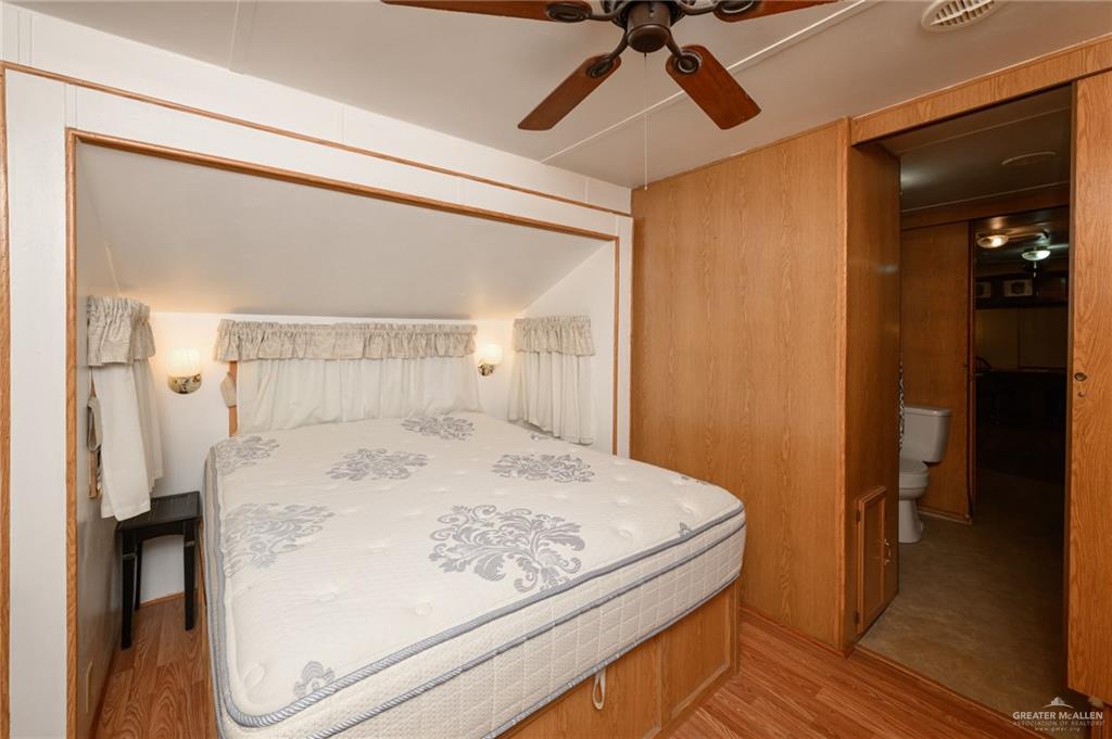 215 South Valley View Road, Unit 227 Donna, TX 78537 - Photo 10 of 18 a bedroom with a bed and a dresser