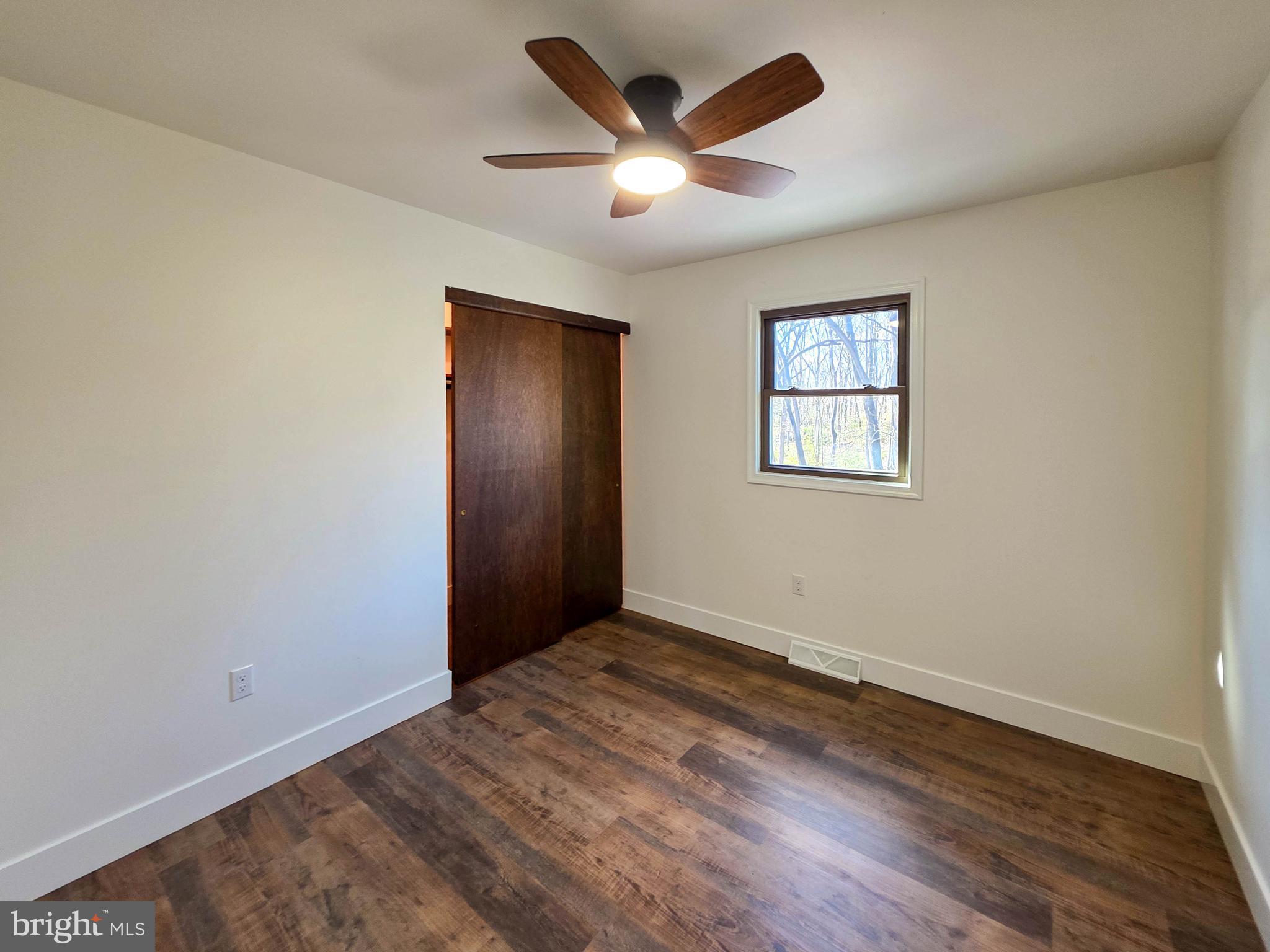 1700 McDowell Road Greencastle, PA 17225 - Photo 13 of 40 an empty room with wooden floor and windows