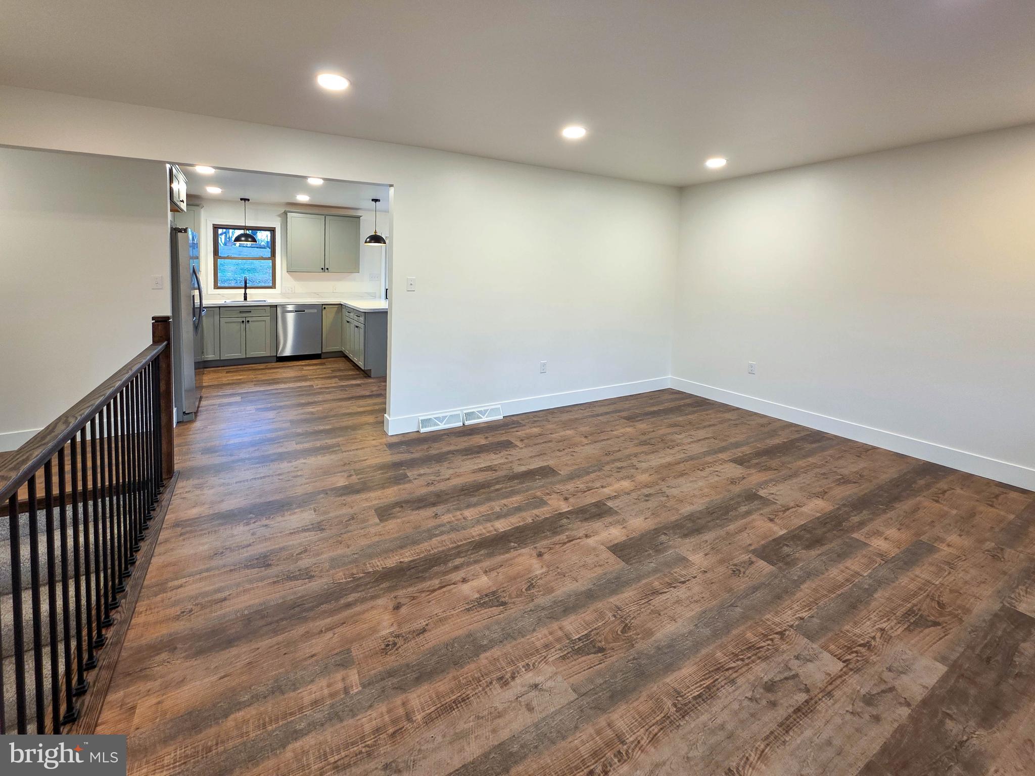 1700 McDowell Road Greencastle, PA 17225 - Photo 33 of 40 an empty room with wooden floor and a kitchen