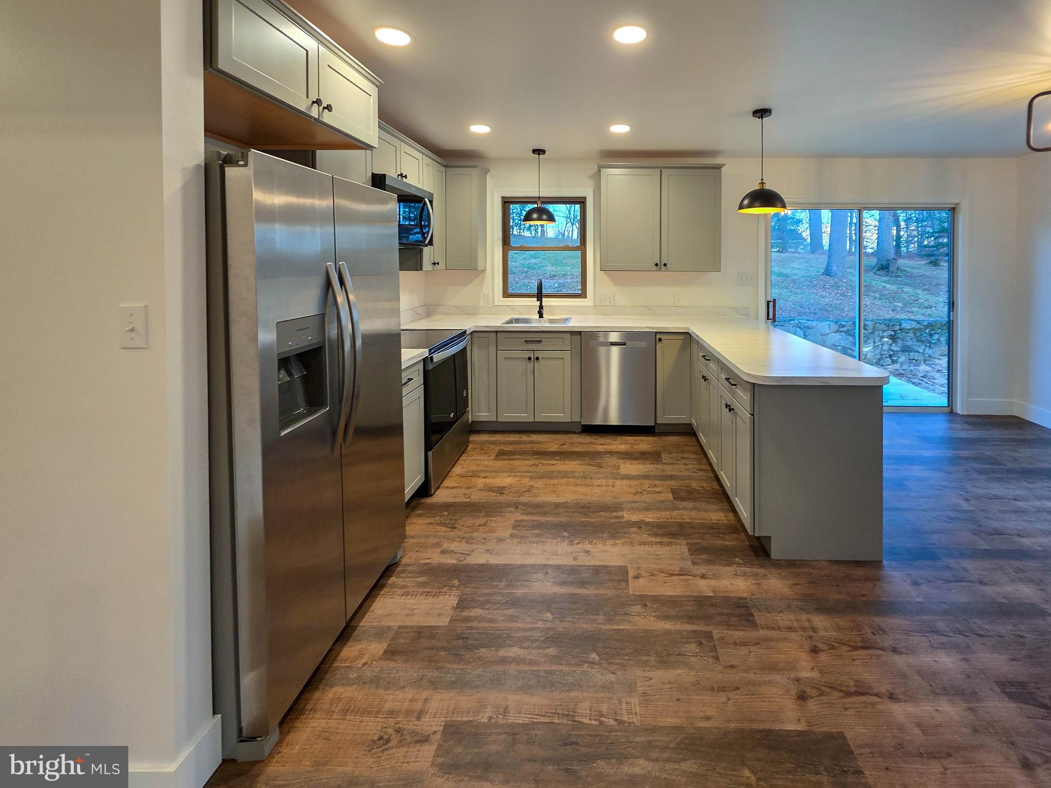 1700 McDowell Road Greencastle, PA 17225 - Photo 36 of 40 a large kitchen with stainless steel appliances a refrigerator and a wooden floor
