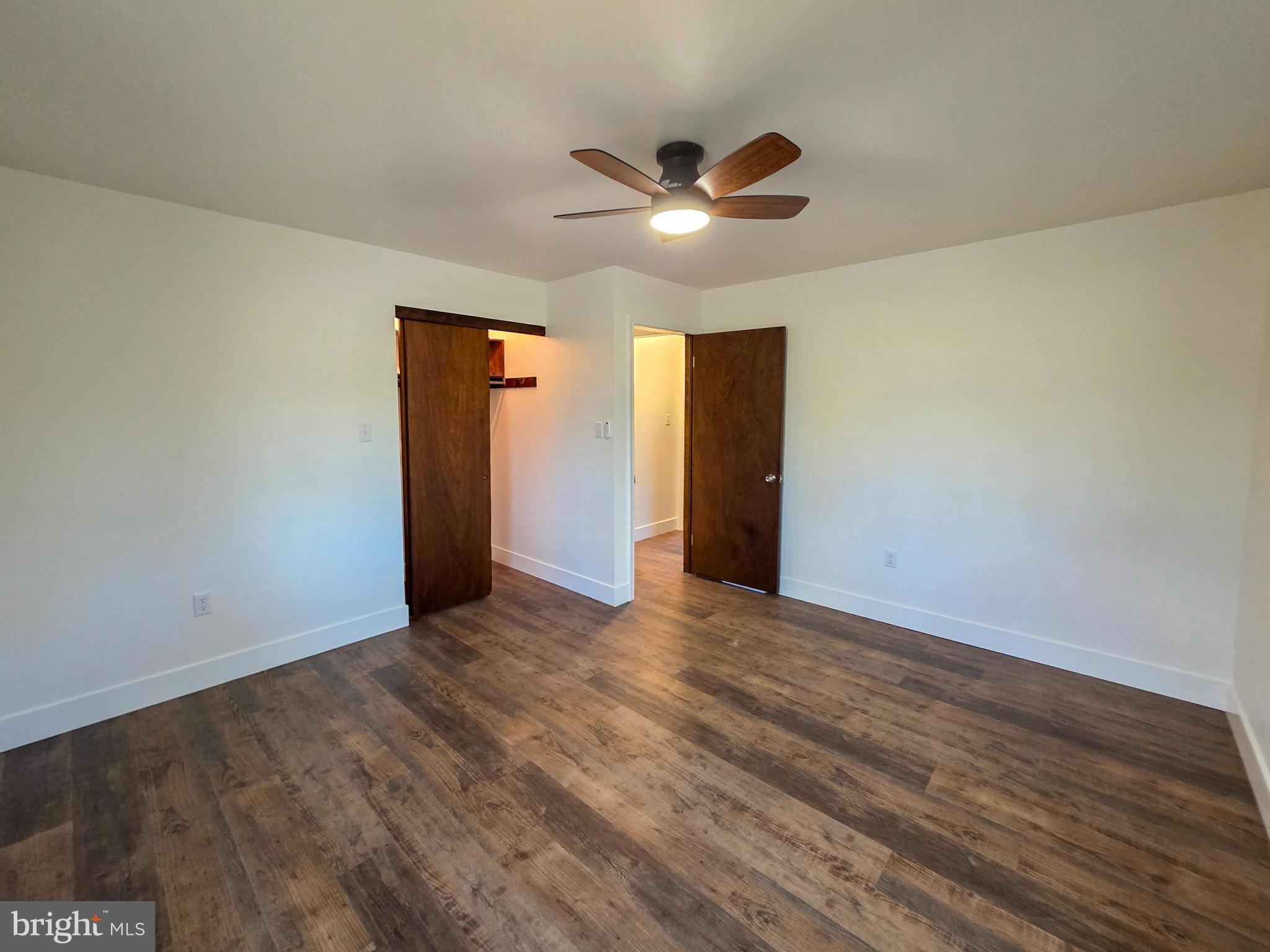 1700 McDowell Road Greencastle, PA 17225 - Photo 10 of 40 a view of an empty room with wooden floor and a ceiling fan