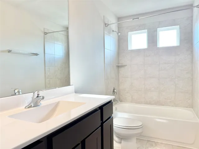 a bathroom with a sink a toilet and a bathtub