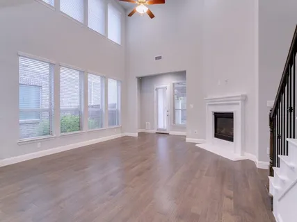 wooden floor fireplace and natural light in room