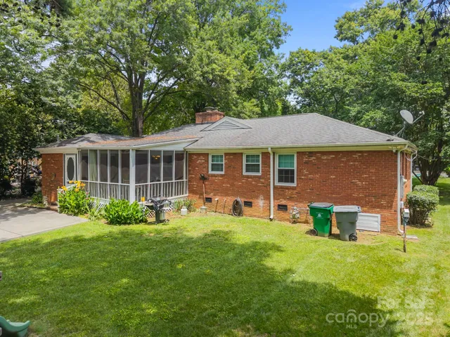 a view of a house with a yard and sitting area