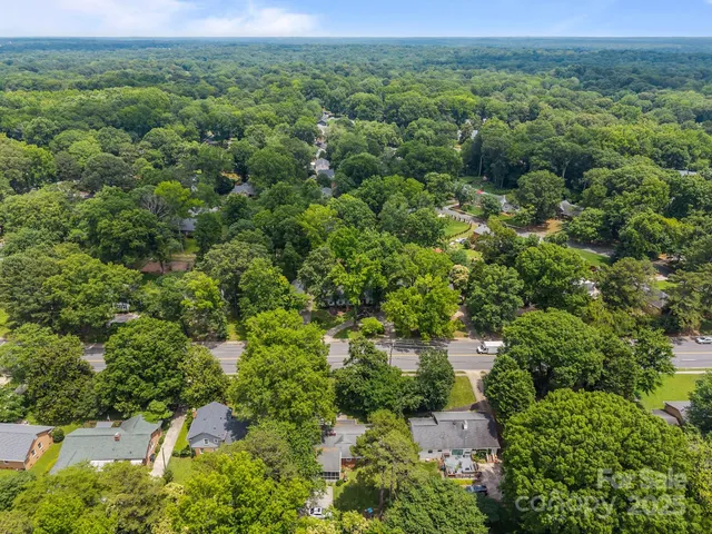 an aerial view of a houses with a yard