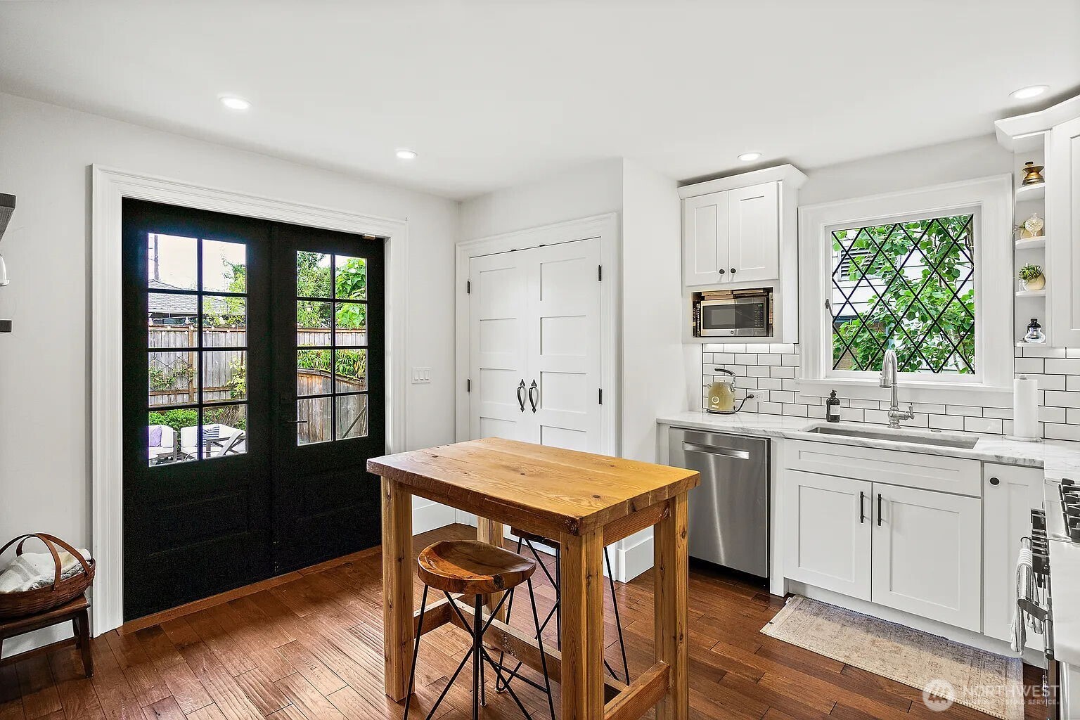 1114 North 77th Street Seattle, WA 98103 - Photo 14 of 30 a kitchen with a table chairs and wooden floor