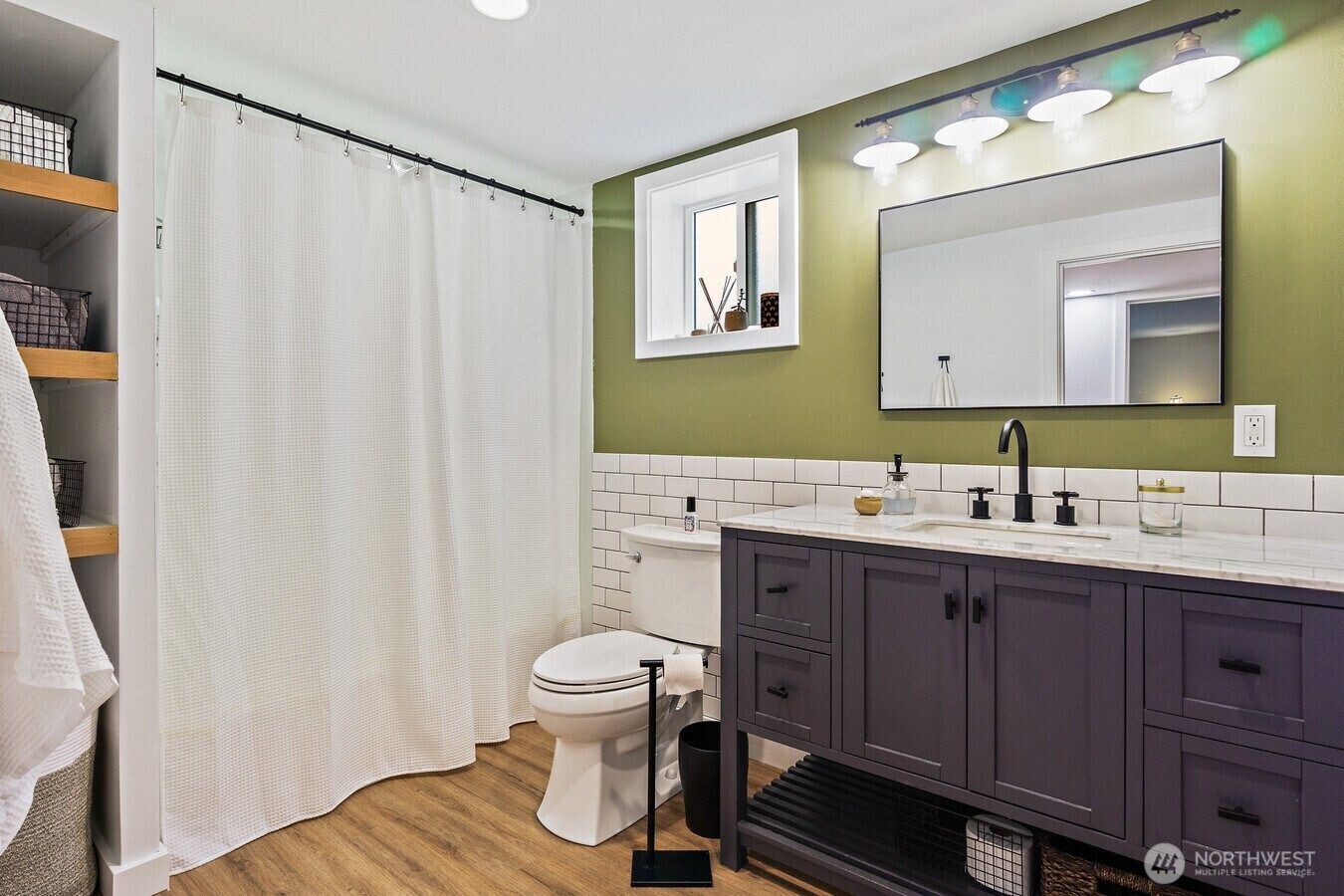 1114 North 77th Street Seattle, WA 98103 - Photo 24 of 30 a bathroom with a toilet sink and mirror