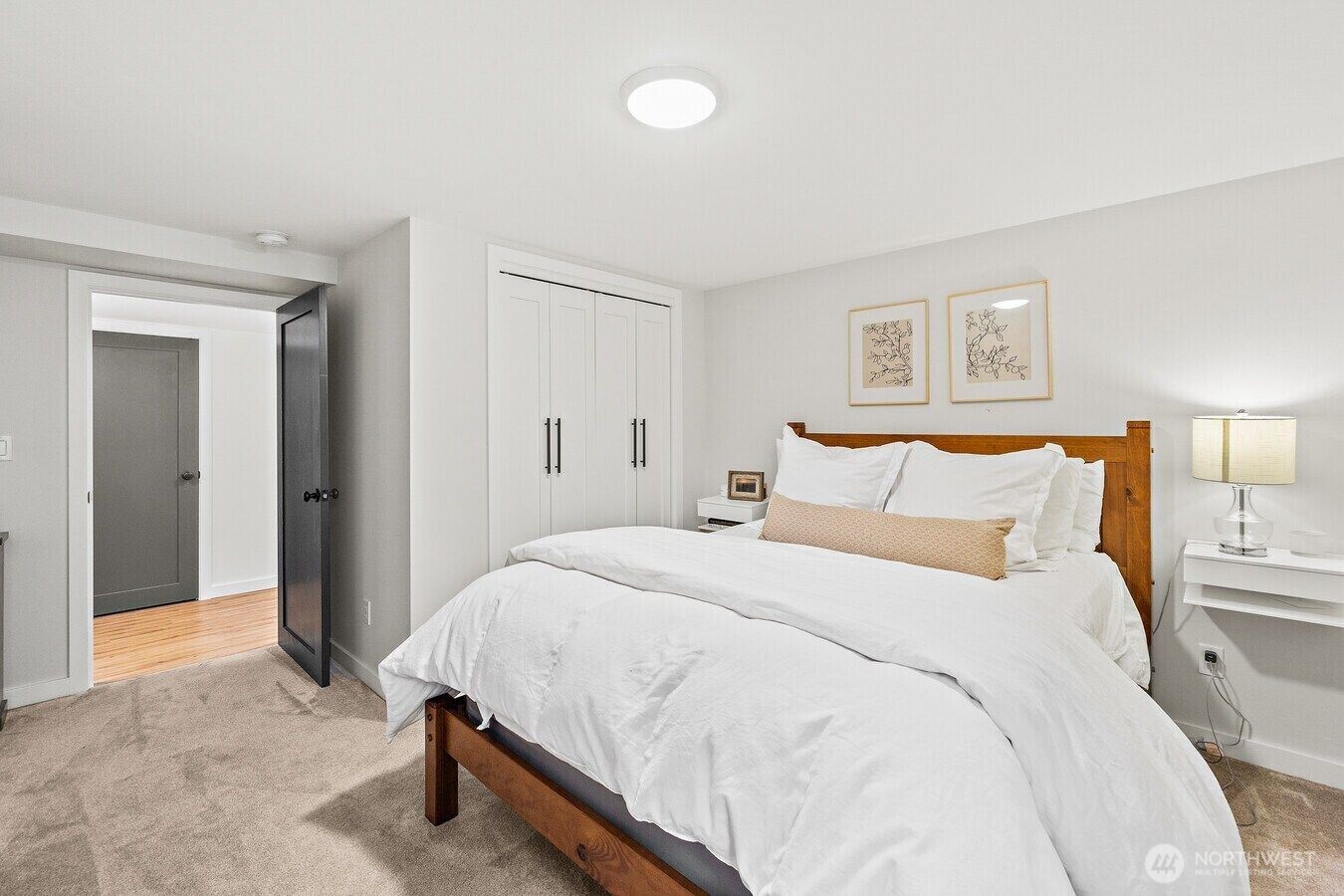 1114 North 77th Street Seattle, WA 98103 - Photo 26 of 30 a large bed sitting in a bedroom and lamp