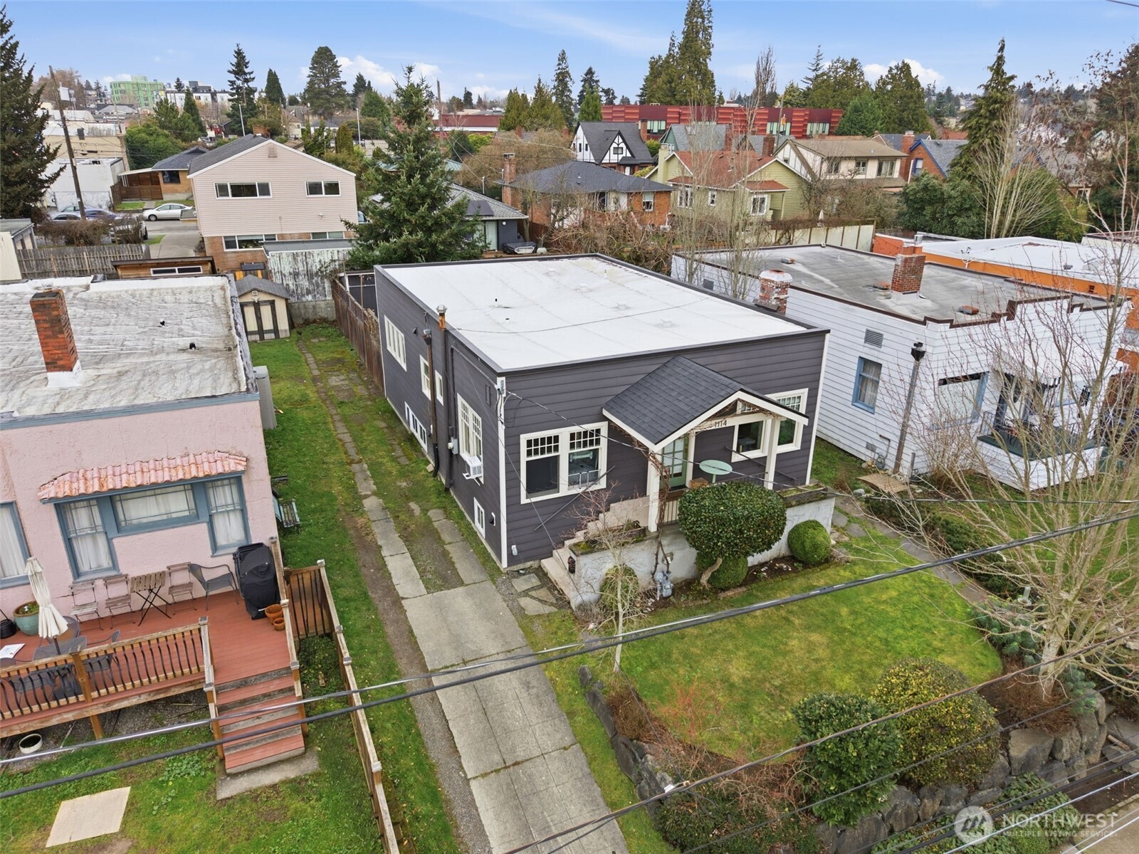 1114 North 77th Street Seattle, WA 98103 - Photo 29 of 30 an aerial view of a house with swimming pool lawn chairs and fire pit