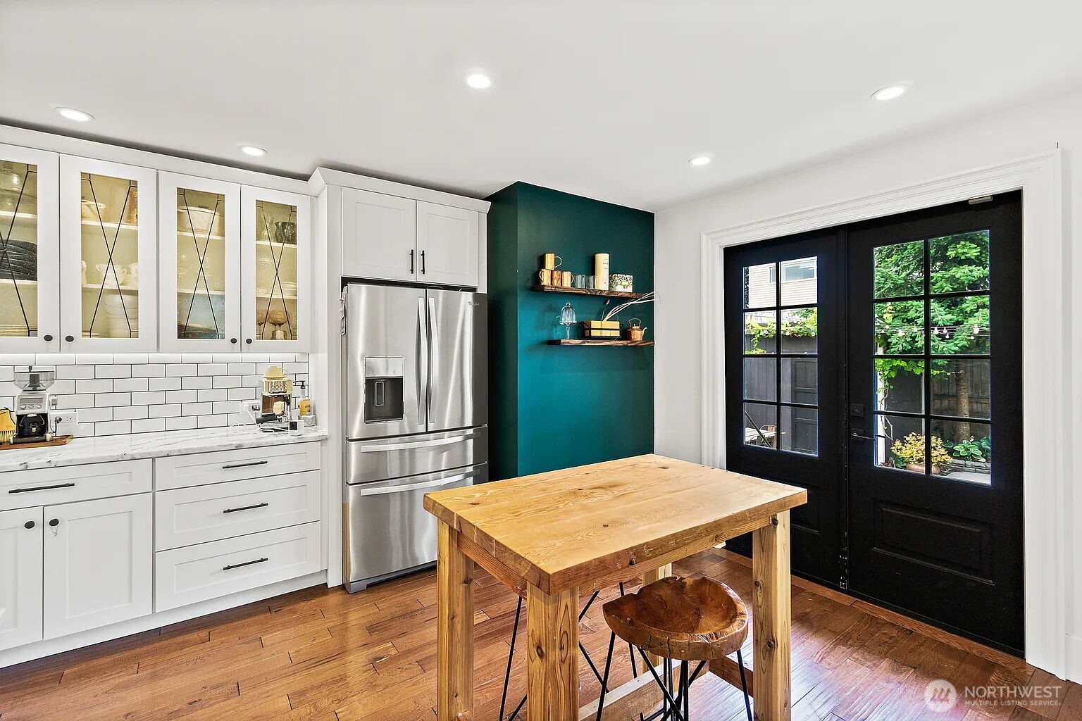 1114 North 77th Street Seattle, WA 98103 - Photo 7 of 30 a kitchen that has a cabinets counter space and stainless steel appliances