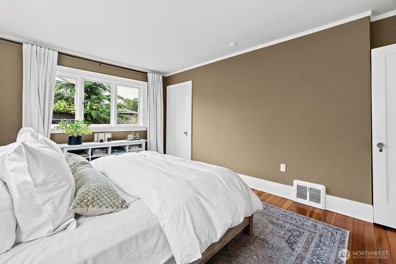 1114 North 77th Street Seattle, WA 98103 - Photo 8 of 30 a bedroom with a bed and a large window