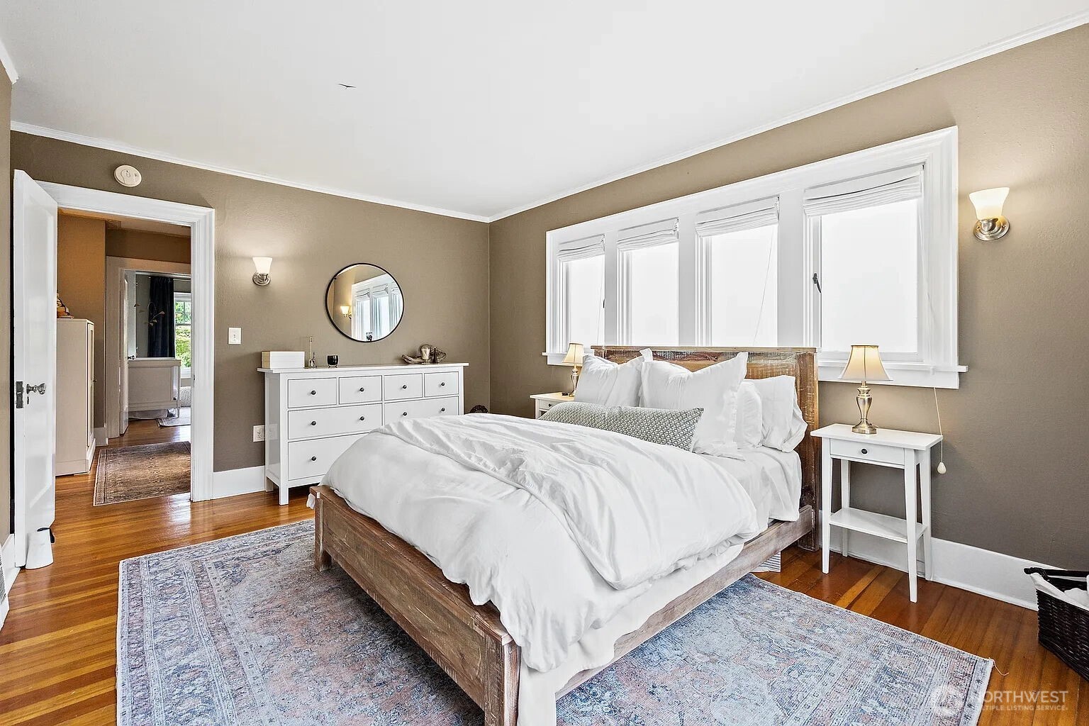 1114 North 77th Street Seattle, WA 98103 - Photo 9 of 30 a large bedroom with a bed and wooden floor