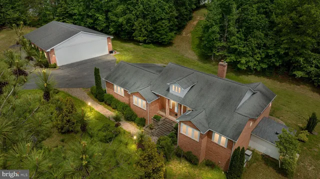 an aerial view of a house with a yard basket ball court and outdoor seating