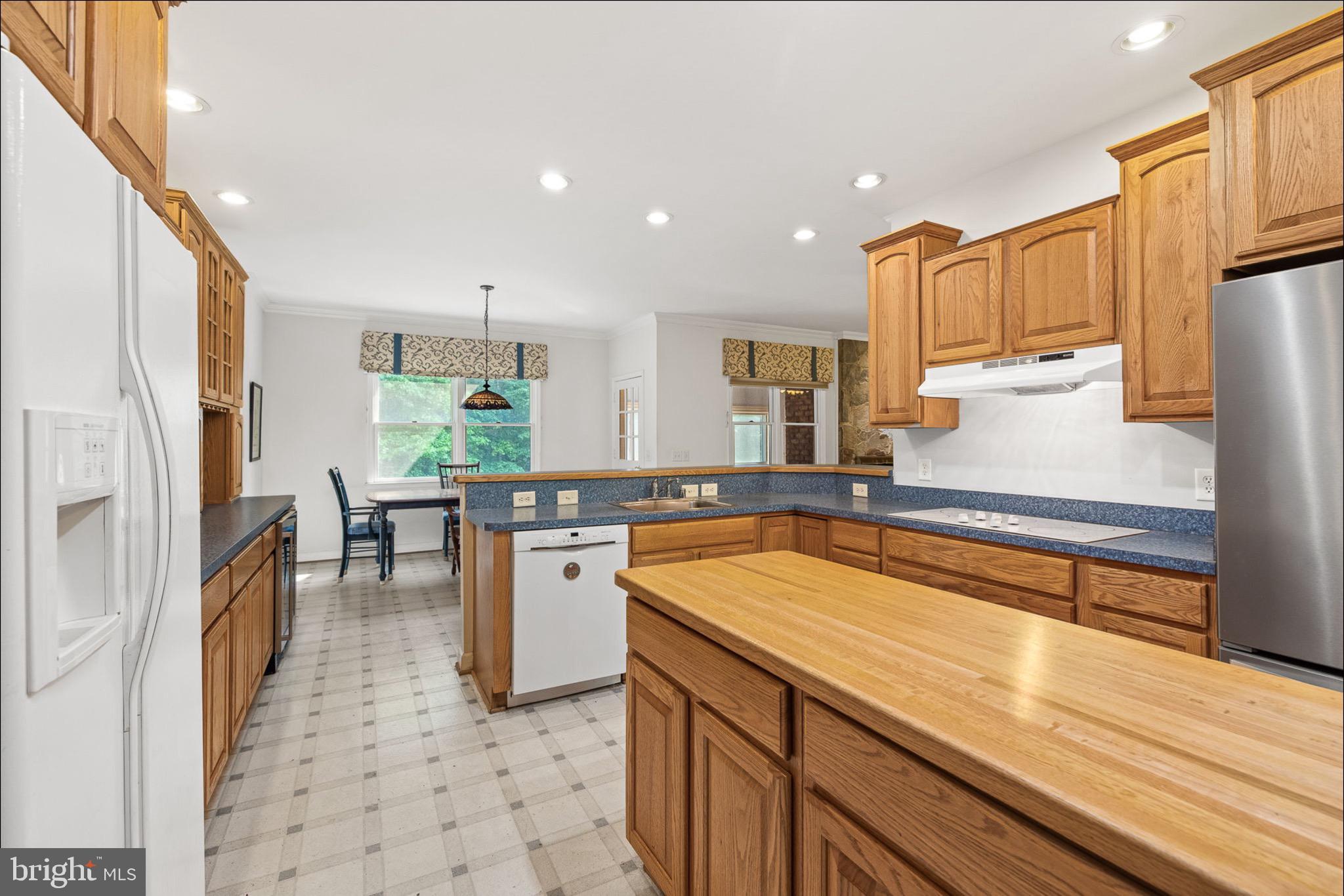 10 Piper Place Fredericksburg, VA 22405 - Photo 12 of 34 a kitchen with stainless steel appliances granite countertop sink refrigerator and cabinets