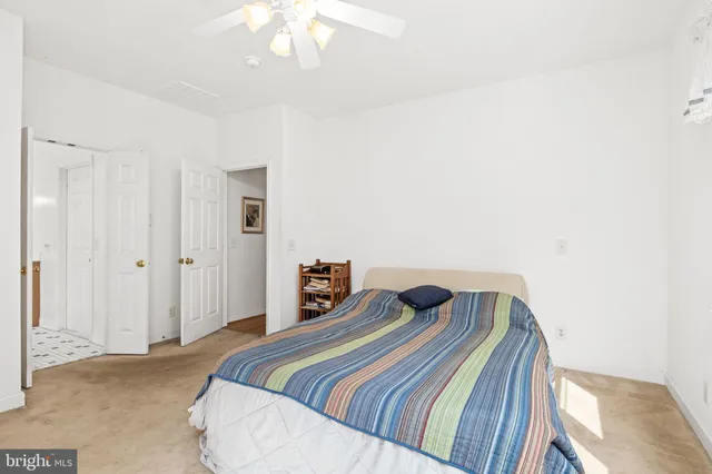a bedroom with a bed and chandelier
