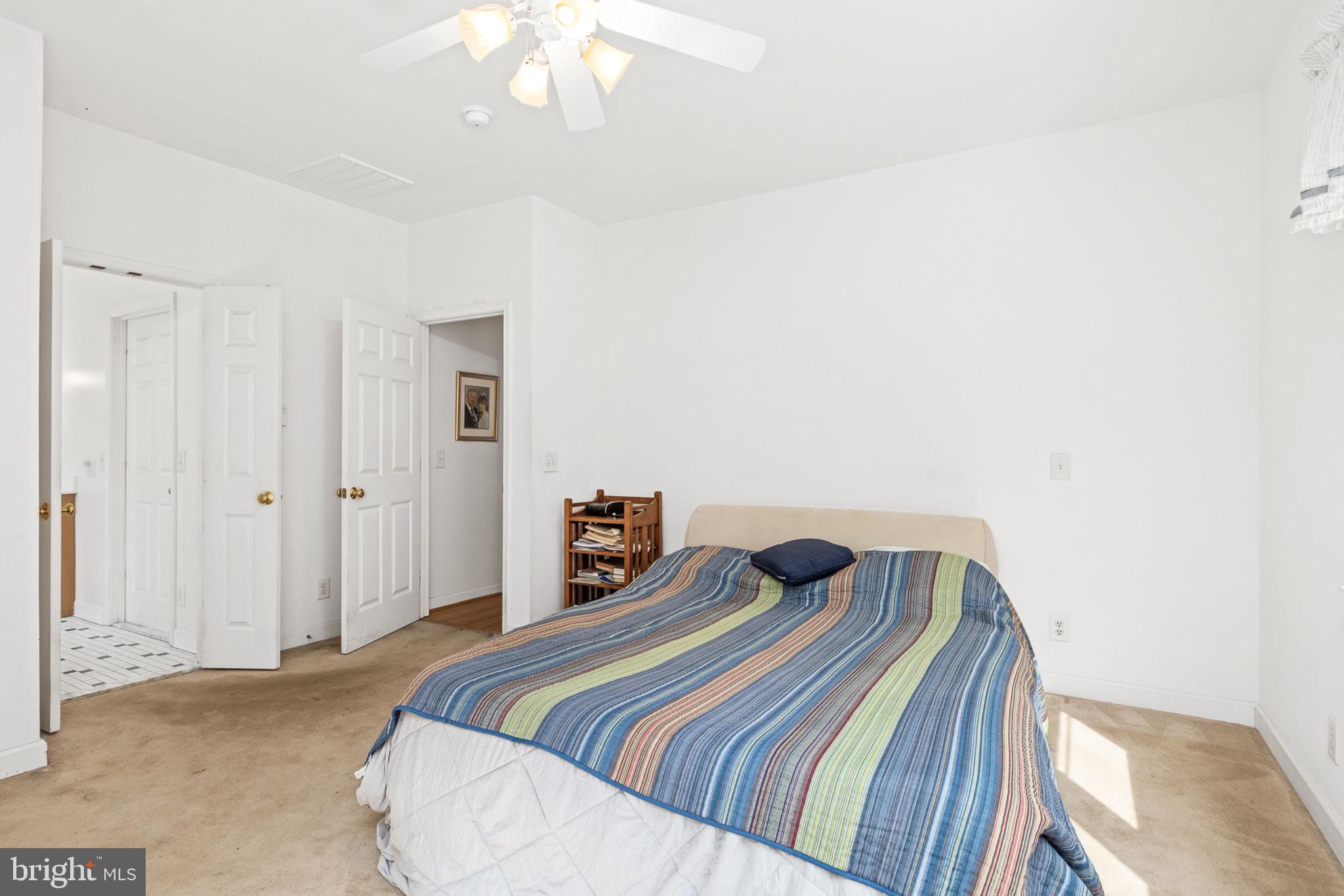 10 Piper Place Fredericksburg, VA 22405 - Photo 20 of 34 a bedroom with a bed and chandelier