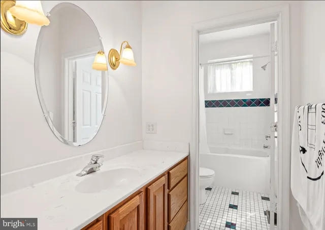 a bathroom with a sink mirror and vanity