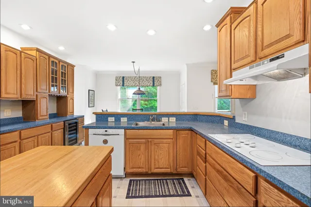 a kitchen with stainless steel appliances a sink stove and cabinets