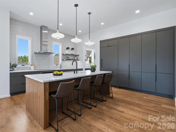 a kitchen with a table chairs and a chandelier