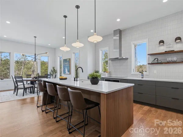 a kitchen with a dining table chairs sink and stove