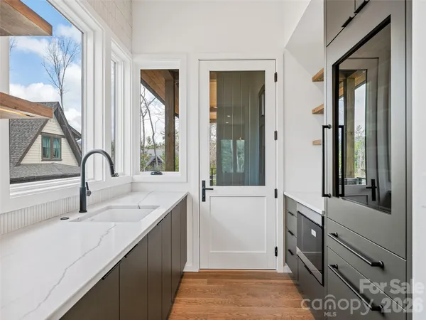 a kitchen with a sink and a large window