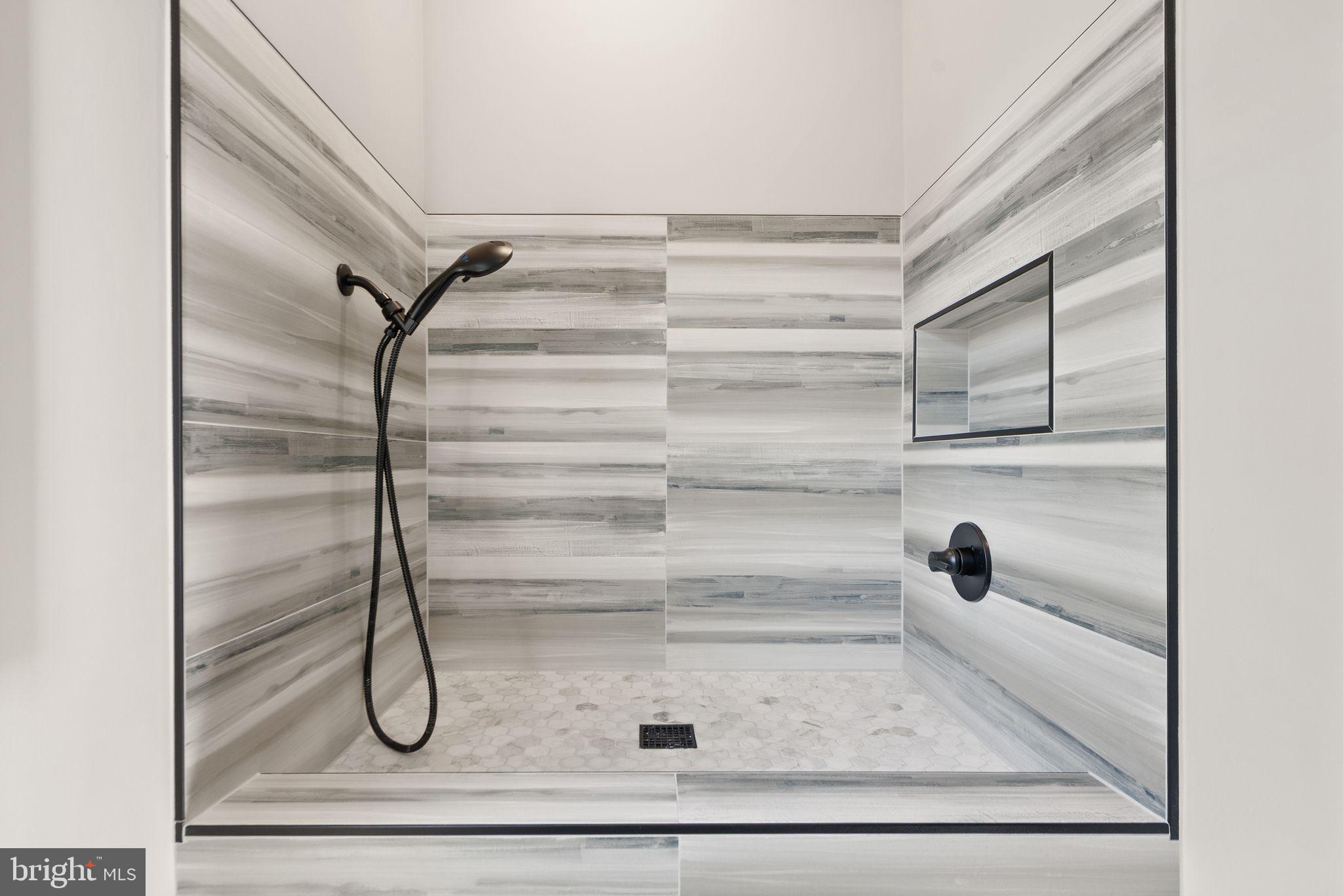 6329 Halsey Road McLean, VA 22101 - Photo 32 of 94 Sleek modern shower with elegant tiles.