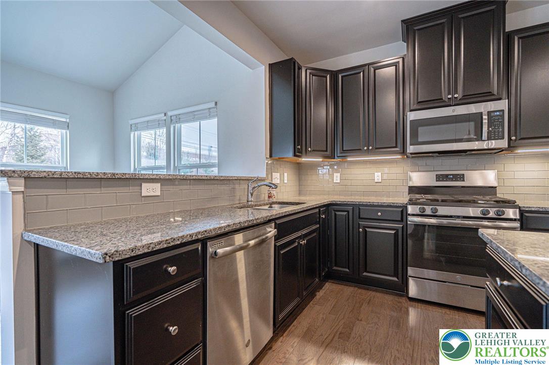 2584 Raya Way Easton, PA 18045 - Photo 15 of 50 a kitchen with stainless steel appliances granite countertop a stove and a sink