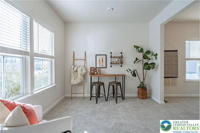 a dining room with furniture a chandelier and window