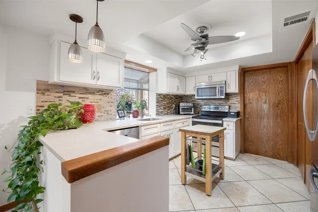 a kitchen with a sink stainless steel appliances and cabinets
