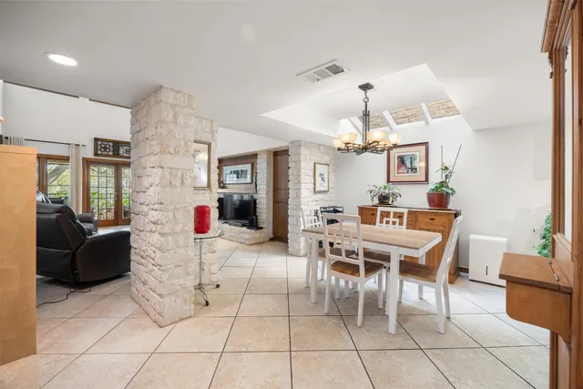 a dining room with furniture and chandelier