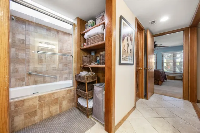 a bathroom with a tub and a glass door shower