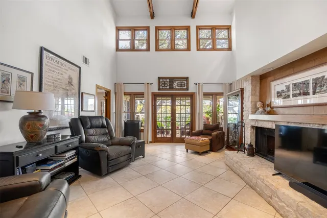 a living room with furniture fireplace and a large window