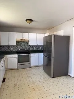 a kitchen with stainless steel appliances granite countertop a refrigerator and a sink