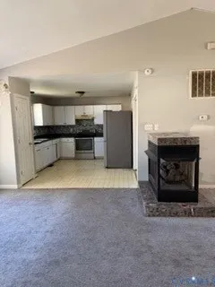 a large kitchen with a stove and a refrigerator