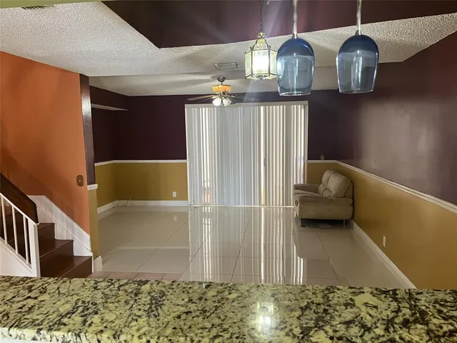 a view of hall way with furniture and chandelier