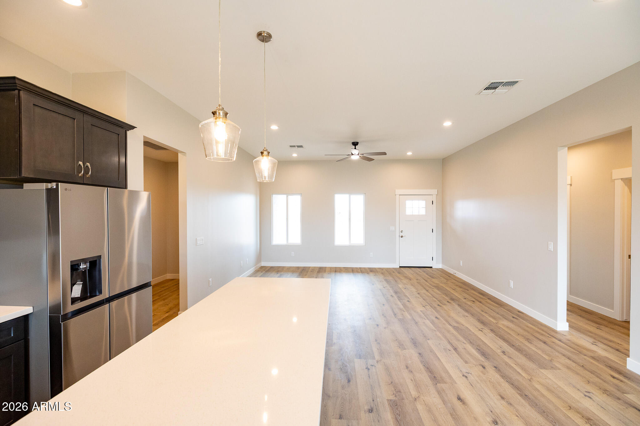 11459 East Adamsville Road Florence, AZ 85132 - Photo 16 of 63 a view of a refrigerator in kitchen and wooden floor