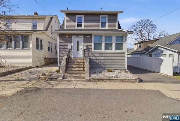 a front view of a house with a road